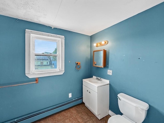 19 High St, Lynn, MA 01902 - bathroom with baseboard heating, vanity, and tile patterned floors