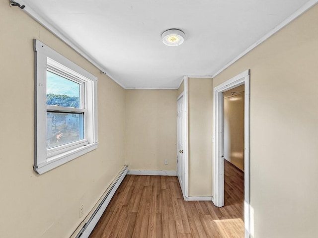 19 High St, Lynn, MA 01902 - unfurnished bedroom with wood finished floors, crown molding, and a baseboard radiator