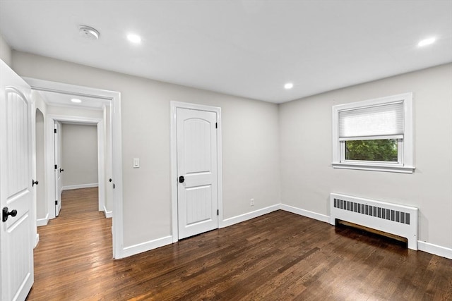 181 Manchester St, Boston, MA 02126 - unfurnished bedroom with radiator heating unit, wood finished floors, and recessed lighting