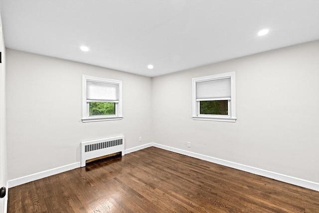 181 Manchester St, Boston, MA 02126 - spare room with radiator heating unit, dark wood finished floors, and recessed lighting