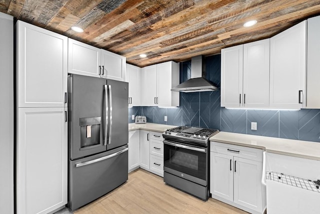 181 Manchester St, Boston, MA 02126 - kitchen featuring appliances with stainless steel finishes, wall chimney range hood, light countertops, wooden ceiling, and light wood finished floors