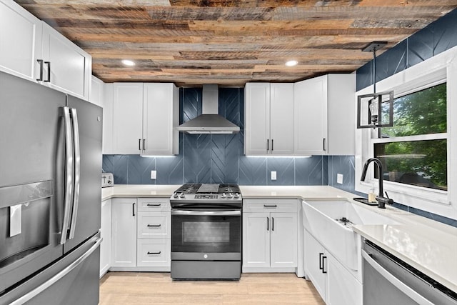 181 Manchester St, Boston, MA 02126 - kitchen featuring stainless steel appliances, wall chimney exhaust hood, wood ceiling, light countertops, and light wood-style flooring