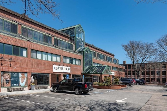 view of building exterior with uncovered parking