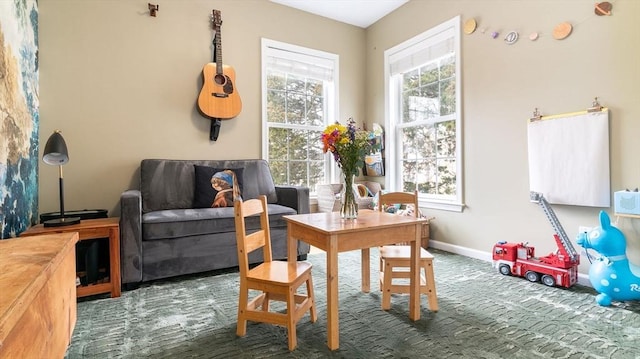 60 Wright St, Arlington, MA 02474 - living area featuring healthy amount of natural light, baseboards, and carpet