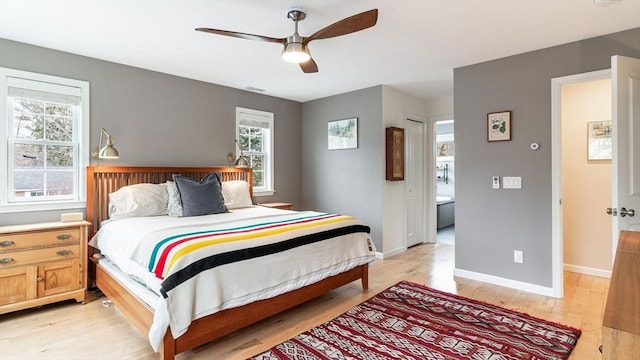 60 Wright St, Arlington, MA 02474 - bedroom with light wood finished floors, baseboards, and ceiling fan