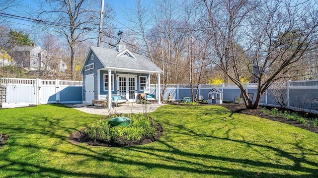 60 Wright St, Arlington, MA 02474 - view of yard with french doors, a patio, an outbuilding, and a gate