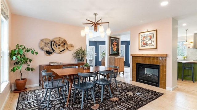 60 Wright St, Arlington, MA 02474 - dining area featuring wood finished floors, a tiled fireplace, recessed lighting, and baseboards