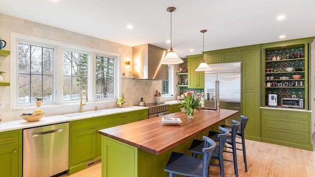 60 Wright St, Arlington, MA 02474 - kitchen with high quality appliances, open shelves, green cabinetry, a sink, and recessed lighting