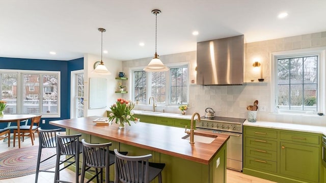60 Wright St, Arlington, MA 02474 - kitchen featuring green cabinetry, butcher block counters, ventilation hood, high end stainless steel range, and a sink