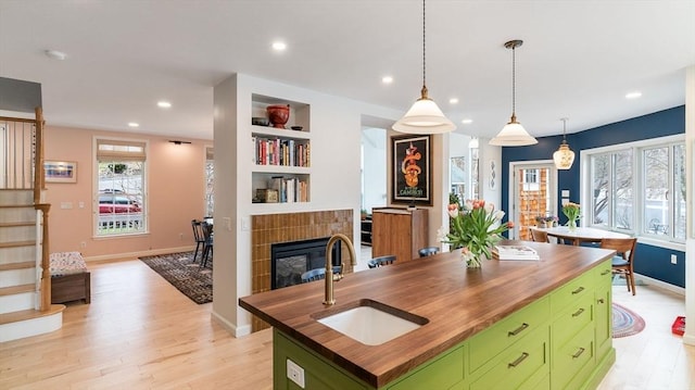 60 Wright St, Arlington, MA 02474 - kitchen featuring wooden counters, green cabinetry, a sink, light wood-style floors, and recessed lighting