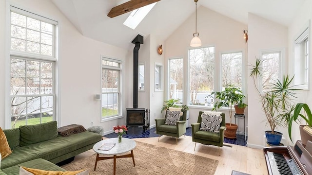 60 Wright St, Arlington, MA 02474 - sunroom featuring a wood stove, healthy amount of natural light, a skylight, and lofted ceiling