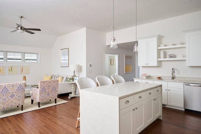 kitchen with decorative light fixtures, white cabinets, dark hardwood / wood-style flooring, stainless steel dishwasher, and a kitchen island