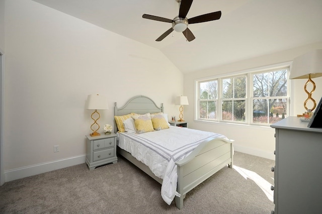 bedroom featuring light colored carpet, vaulted ceiling, and ceiling fan