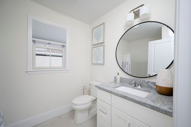 bathroom featuring tile floors, vanity with extensive cabinet space, and toilet