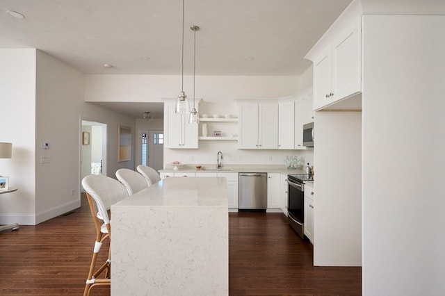 kitchen featuring pendant lighting, dark hardwood / wood-style flooring, and white cabinets