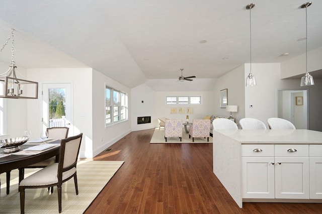 kitchen with decorative light fixtures, dark hardwood / wood-style flooring, and white cabinets