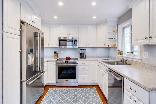 18 Tupelo, Harwich, MA 02645 - kitchen with premium appliances, a sink, dark wood finished floors, white cabinetry, and light countertops