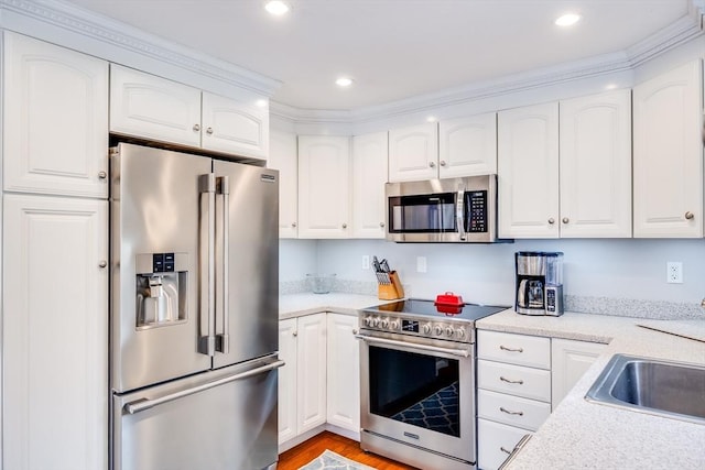 18 Tupelo, Harwich, MA 02645 - kitchen featuring stainless steel appliances, white cabinets, light countertops, and recessed lighting