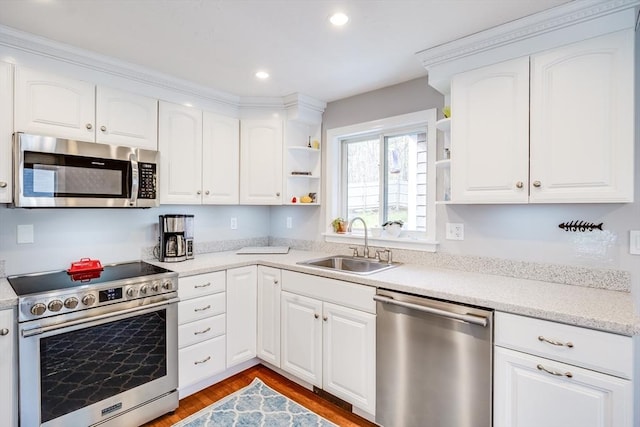 18 Tupelo, Harwich, MA 02645 - kitchen with appliances with stainless steel finishes, a sink, open shelves, wood finished floors, and white cabinets