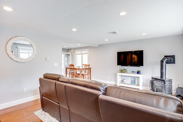18 Tupelo, Harwich, MA 02645 - living area with baseboards, recessed lighting, light wood finished floors, and a wood stove