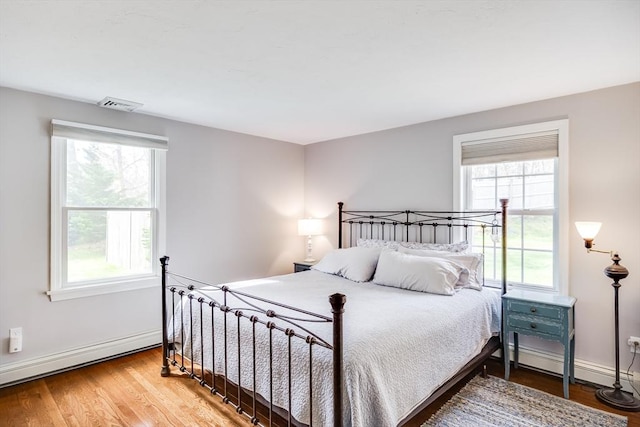 18 Tupelo, Harwich, MA 02645 - bedroom with a baseboard radiator, baseboards, and wood finished floors