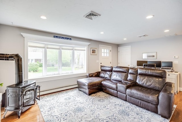 18 Tupelo, Harwich, MA 02645 - living area featuring light wood-style flooring, recessed lighting, a baseboard radiator, and a wood stove