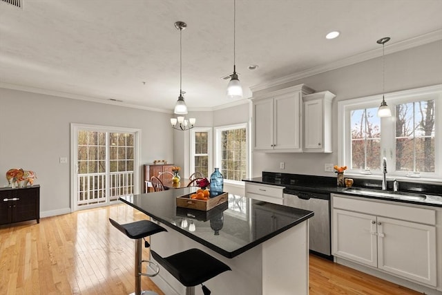 30 Compass Pt Unit 30, North Andover, MA 01845 - kitchen with stainless steel dishwasher, plenty of natural light, white cabinetry, ornamental molding, and a chandelier