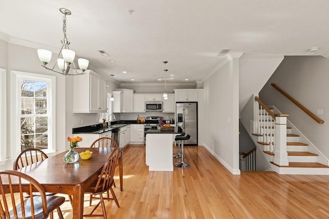 30 Compass Pt Unit 30, North Andover, MA 01845 - dining room featuring light wood finished floors, stairs, a chandelier, crown molding, and recessed lighting