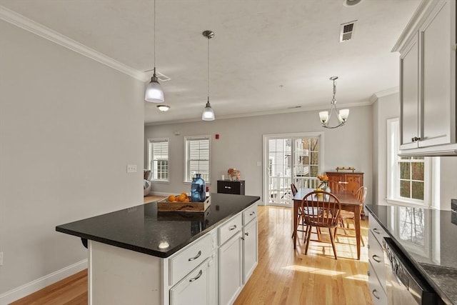 30 Compass Pt Unit 30, North Andover, MA 01845 - kitchen featuring light wood-type flooring, ornamental molding, pendant lighting, white cabinets, and a center island