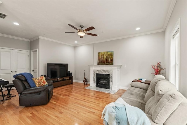 30 Compass Pt Unit 30, North Andover, MA 01845 - living room featuring light wood-style floors, ceiling fan, recessed lighting, a high end fireplace, and crown molding
