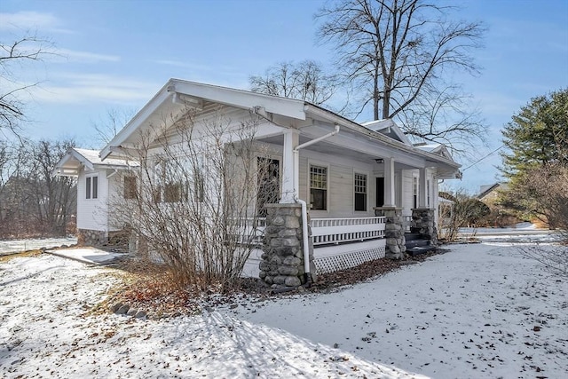 view of snow covered exterior featuring a porch