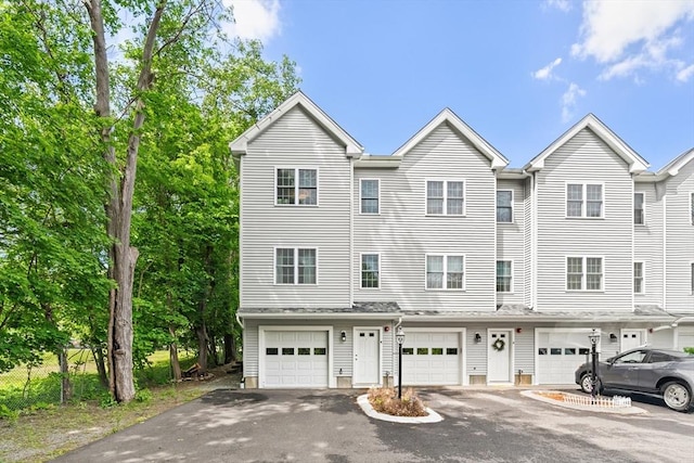 35 Fredonian St Unit K, Shirley, MA 01464 - view of property featuring an attached garage and driveway