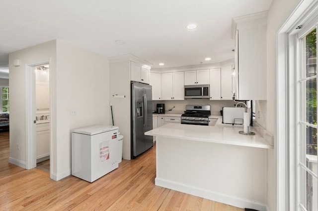 35 Fredonian St Unit K, Shirley, MA 01464 - kitchen featuring stainless steel appliances, plenty of natural light, a peninsula, light wood finished floors, and recessed lighting