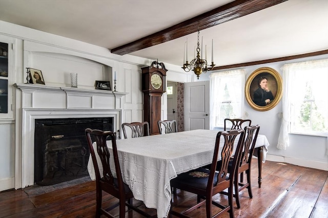 79 Nobscot Rd, Sudbury, MA 01776 - dining room featuring a chandelier, dark wood-type flooring, beamed ceiling, baseboards, and a fireplace with flush hearth