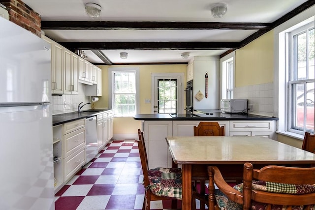 79 Nobscot Rd, Sudbury, MA 01776 - kitchen featuring black appliances, dark floors, healthy amount of natural light, beam ceiling, and a peninsula