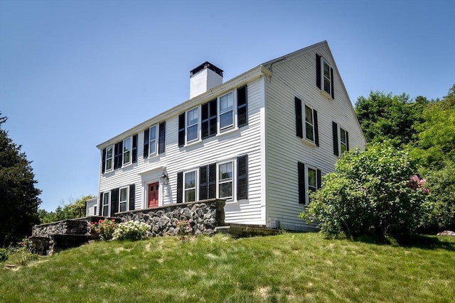 79 Nobscot Rd, Sudbury, MA 01776 - view of home's exterior featuring a chimney and a lawn