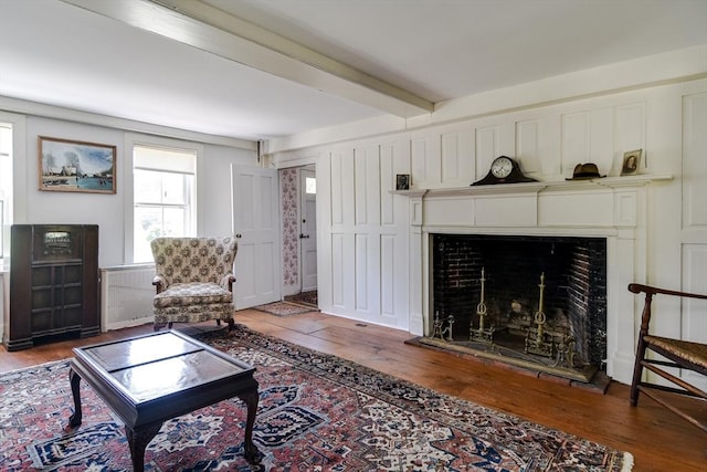 79 Nobscot Rd, Sudbury, MA 01776 - living room with hardwood / wood-style floors, a fireplace with raised hearth, and beamed ceiling