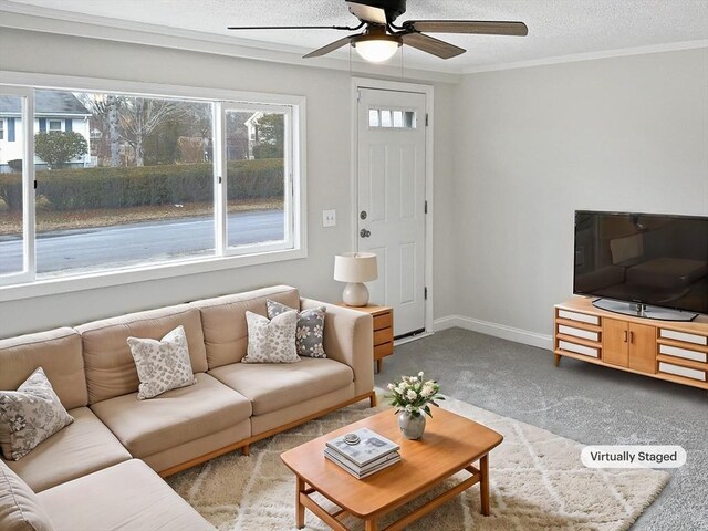 living room featuring light carpet, ceiling fan, a textured ceiling, and plenty of natural light