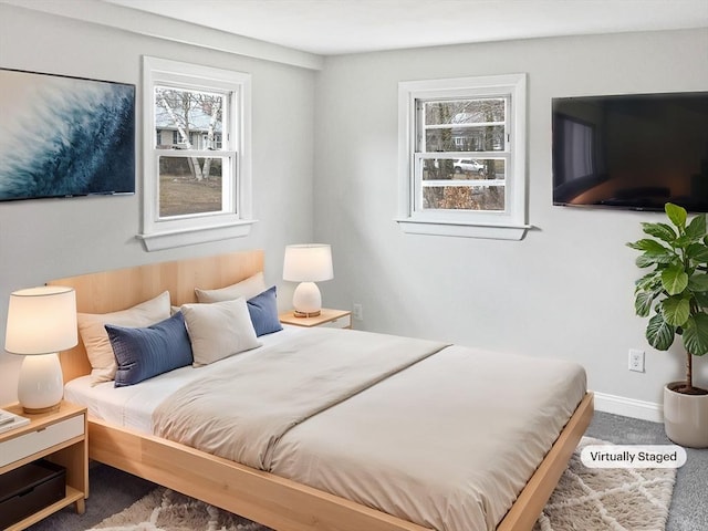 bedroom with carpet and multiple windows