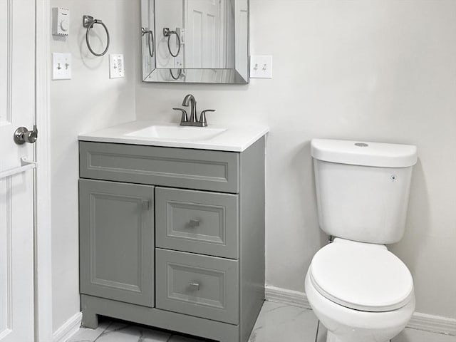 bathroom featuring toilet and vanity