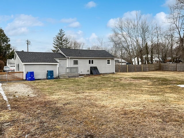 rear view of property featuring a lawn