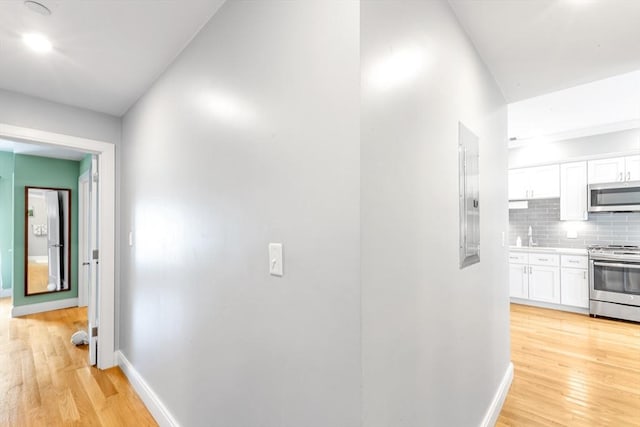 37-39 Lamson St Unit 2, Boston, MA 02128 - hallway with baseboards, light wood-style flooring, and a sink