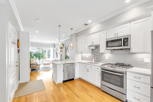 37-39 Lamson St Unit 2, Boston, MA 02128 - kitchen featuring appliances with stainless steel finishes, a sink, light countertops, white cabinetry, and light wood-style flooring
