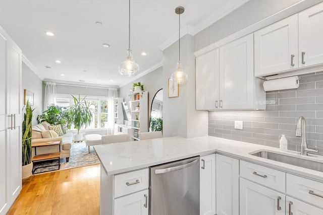 37-39 Lamson St Unit 2, Boston, MA 02128 - kitchen with stainless steel dishwasher, a sink, crown molding, a peninsula, and light wood finished floors