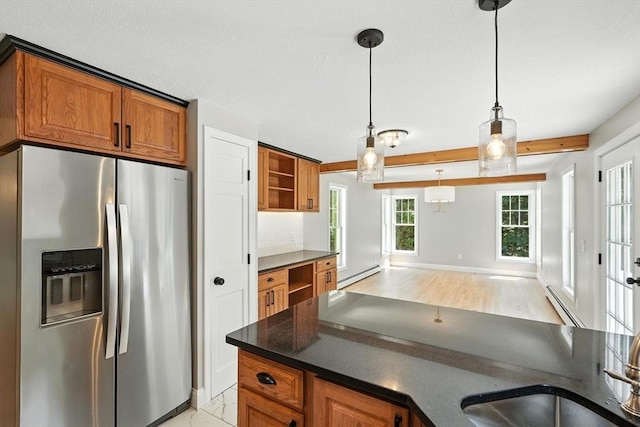147 Mort Vining Rd, Southwick, MA 01077 - kitchen with stainless steel fridge, a baseboard radiator, dark countertops, brown cabinetry, and beam ceiling