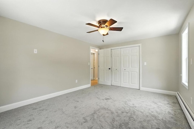 147 Mort Vining Rd, Southwick, MA 01077 - unfurnished bedroom with a baseboard radiator, carpet flooring, a closet, and a ceiling fan