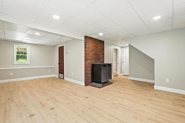 147 Mort Vining Rd, Southwick, MA 01077 - unfurnished living room with a wood stove, light wood finished floors, a paneled ceiling, and recessed lighting