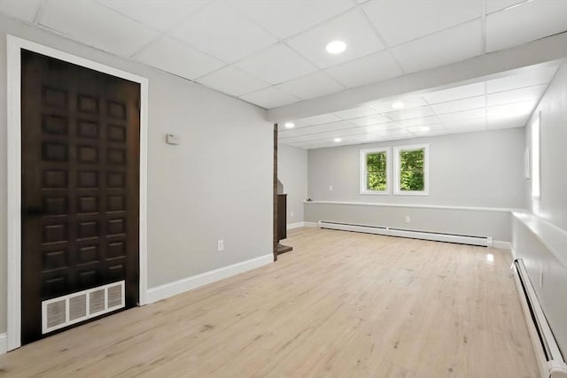 147 Mort Vining Rd, Southwick, MA 01077 - below grade area with a baseboard heating unit, wood finished floors, a drop ceiling, and recessed lighting