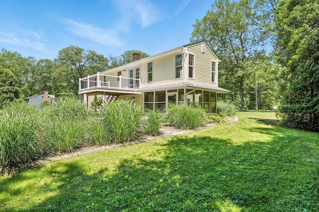 147 Mort Vining Rd, Southwick, MA 01077 - rear view of house with a sunroom, a chimney, a yard, and a wooden deck