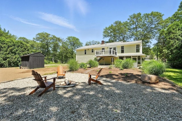147 Mort Vining Rd, Southwick, MA 01077 - back of property with an outdoor fire pit, a storage shed, a chimney, and a wooden deck